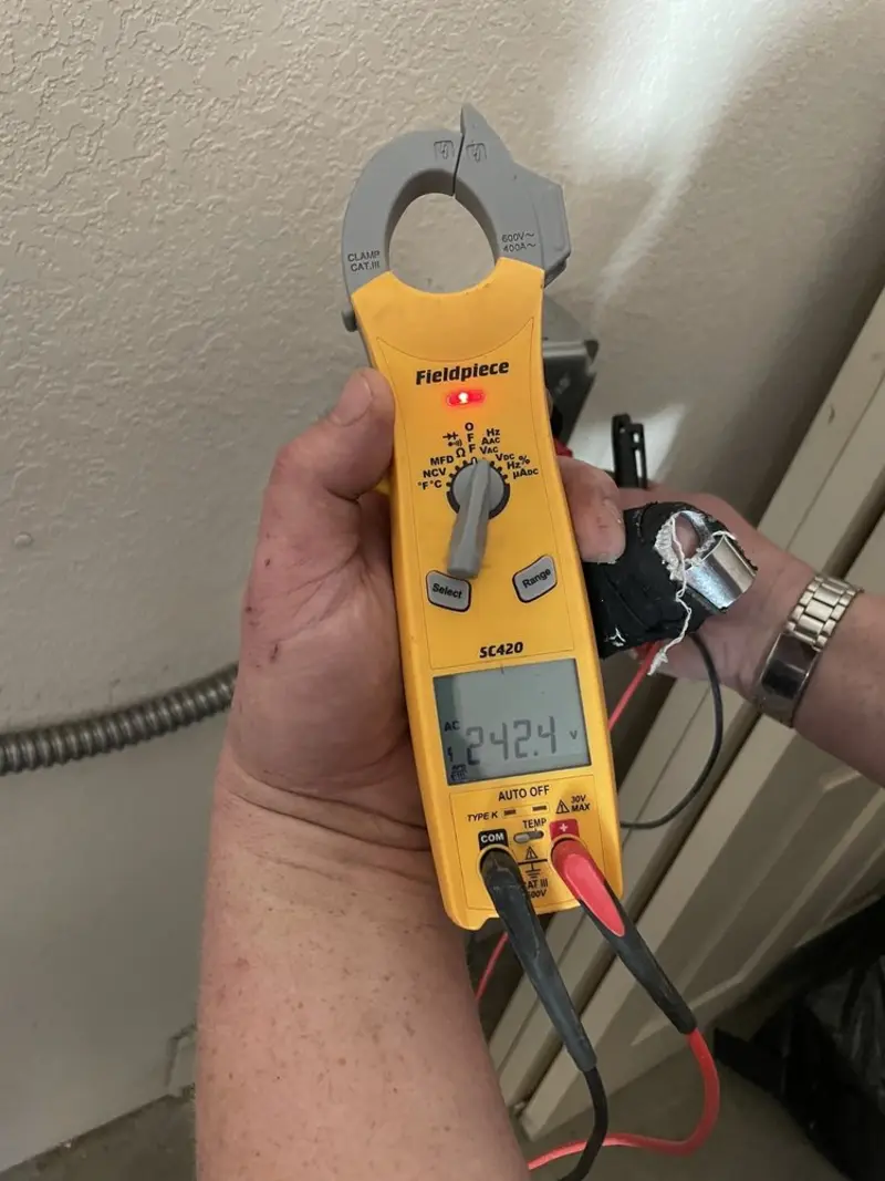 Voltage testing with clamp meter during Recessed Lighting Installation in Heber